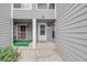 Welcoming front entrance with a gray exterior, a storm door, and charming entryway decor at 12717 E Cornell Ave, Aurora, CO 80014