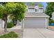 Charming two-story home with gray siding, attached garage, and landscaped front yard at 12717 E Cornell Ave, Aurora, CO 80014