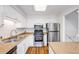 Bright kitchen features stainless steel appliances, wood floors and ample cabinet and counter space at 12717 E Cornell Ave, Aurora, CO 80014