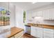 This airy kitchen features stainless steel appliances, natural light and updated cabinetry at 12717 E Cornell Ave, Aurora, CO 80014