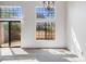 Bright living room with multiple windows and a sliding glass door for natural light at 12717 E Cornell Ave, Aurora, CO 80014