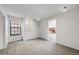 A cozy living room features neutral carpet and paint, large windows and a fireplace at 12717 E Cornell Ave, Aurora, CO 80014