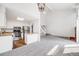 Open living space featuring a kitchen with stainless steel appliances and a staircase to the second floor at 12717 E Cornell Ave, Aurora, CO 80014