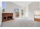 Spacious living room featuring vaulted ceilings, fireplace, and sliding glass doors to the backyard at 12717 E Cornell Ave, Aurora, CO 80014