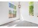 Bright living room with oversized windows and modern hanging light fixture at 12717 E Cornell Ave, Aurora, CO 80014