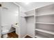 This walk-in closet is spacious with lots of built-in shelving and direct access to the en-suite bathroom at 12717 E Cornell Ave, Aurora, CO 80014