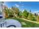 Large backyard with stamped concrete patio, mature trees, and fence, creating a private outdoor space at 3505 Dinosaur St, Castle Rock, CO 80109