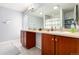 Bathroom features double sinks, wooden cabinets, tile floor, and a mirror at 3505 Dinosaur St, Castle Rock, CO 80109