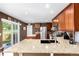 Modern kitchen featuring granite countertops, stainless steel appliances, and access to the backyard at 3505 Dinosaur St, Castle Rock, CO 80109