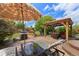 Landscaped backyard features covered pergola, outdoor grill, seating and sunny patio space at 11961 S Saunter Ln, Parker, CO 80138