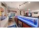 Finished basement bar featuring illuminated countertop, seating, mini fridge and fun decor at 11961 S Saunter Ln, Parker, CO 80138