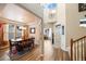 Elegant dining room with hardwood floors, chandelier, and views of the foyer at 11961 S Saunter Ln, Parker, CO 80138