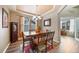 Bright dining area featuring wood floors, a modern chandelier, and large windows for lots of natural light at 11961 S Saunter Ln, Parker, CO 80138