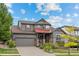 Charming two-story home showcasing inviting curb appeal with a manicured lawn and lovely landscaping at 11961 S Saunter Ln, Parker, CO 80138
