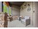 Charming front porch with comfortable seating, stone pillars, and welcoming decor at 11961 S Saunter Ln, Parker, CO 80138