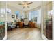 Bright home office with wood floors, a large desk, and multiple windows offering natural light at 11961 S Saunter Ln, Parker, CO 80138