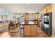 Well-designed kitchen featuring stainless steel appliances, wood cabinets, and a large center island at 11961 S Saunter Ln, Parker, CO 80138