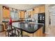 Contemporary kitchen boasting dark countertops, stainless steel appliances, and ample wood cabinetry at 11961 S Saunter Ln, Parker, CO 80138