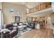 Open-concept living room with soaring ceilings and a view of the upper-level loft at 11961 S Saunter Ln, Parker, CO 80138