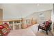 Open loft area features neutral carpeting, wood railing, sitting area, and natural light at 11961 S Saunter Ln, Parker, CO 80138