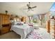Bright main bedroom with vaulted ceiling, en-suite, and large windows overlooking the backyard at 11961 S Saunter Ln, Parker, CO 80138