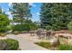 Outdoor patio with seating area, surrounded by trees, plants and shrubbery at 11961 S Saunter Ln, Parker, CO 80138