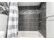 Stylish bathroom with dark tile accents in the tub/shower, featuring modern fixtures and a shower curtain at 5250 S Huron Way # 13-312, Littleton, CO 80120