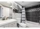 Updated bathroom with sleek vanity, modern fixtures, and stylish black and white tile accents at 5250 S Huron Way # 13-312, Littleton, CO 80120