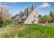 Rear view of a modern townhome featuring a private patio and well-manicured lawn at 5250 S Huron Way # 13-312, Littleton, CO 80120