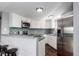 Bright kitchen features stainless steel appliances, blue tile backsplash and a breakfast bar with seating at 5250 S Huron Way # 13-312, Littleton, CO 80120