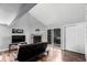 Open concept living room features hardwood floors, fireplace and access to a private balcony at 5250 S Huron Way # 13-312, Littleton, CO 80120