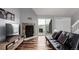 Spacious living room with a fireplace, hardwood floors and access to the balcony at 5250 S Huron Way # 13-312, Littleton, CO 80120