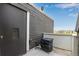 Balcony showing storage unit with horizontal siding, concrete patio floor, and a partial scenic view at 5250 S Huron Way # 13-312, Littleton, CO 80120
