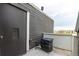 Balcony showing storage unit with horizontal siding, concrete patio floor, and a partial scenic view at 5250 S Huron Way # 13-312, Littleton, CO 80120
