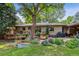 Spacious backyard with deck, landscaping, and lawn at 2872 S Zenobia St, Denver, CO 80236