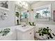 Clean bathroom with white vanity, neutral walls, and decorative plants at 2872 S Zenobia St, Denver, CO 80236