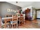 Bright dining room features hardwood floors and a rustic wooden table with seating for four at 2872 S Zenobia St, Denver, CO 80236