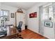 Home office with hardwood floors, built-in shelving, and a large desk at 2872 S Zenobia St, Denver, CO 80236