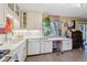 White kitchen with stainless steel appliances and an eat-in kitchen area at 2872 S Zenobia St, Denver, CO 80236