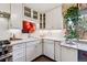 Modern kitchen featuring white cabinets, quartz countertops, and a breakfast bar at 2872 S Zenobia St, Denver, CO 80236