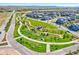A picturesque community view showcases lush green spaces, walking paths, and well-maintained homes in a serene setting at 8056 Piney River Ave, Littleton, CO 80125