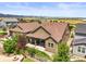 A beautiful aerial view showcases the manicured backyard and neighboring homes and views at 8056 Piney River Ave, Littleton, CO 80125