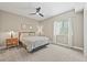 Comfortable bedroom featuring neutral walls, plush carpet, modern ceiling fan, and a queen sized bed at 8056 Piney River Ave, Littleton, CO 80125