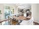 Dining area open to the kitchen, featuring an oval table, stylish chairs, and sliding doors to the patio at 8056 Piney River Ave, Littleton, CO 80125