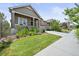 Charming home with a well-manicured lawn, beautiful landscaping, and a cozy front porch, creating a welcoming curb appeal at 8056 Piney River Ave, Littleton, CO 80125