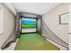 Basement golf simulator features a screen, net, and artificial turf at 8056 Piney River Ave, Littleton, CO 80125