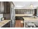 Kitchen with dark wood cabinetry, stainless steel appliances, and granite countertops with a breakfast bar at 8056 Piney River Ave, Littleton, CO 80125