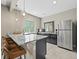 Modern kitchenette with granite countertops, stainless steel appliances, and bar seating at 8056 Piney River Ave, Littleton, CO 80125