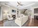Cozy living room featuring a fireplace, open staircase, and seamless flow into the kitchen, perfect for modern living at 8056 Piney River Ave, Littleton, CO 80125