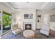 Inviting living room featuring a fireplace, seating, and sliding glass door access to the backyard at 8056 Piney River Ave, Littleton, CO 80125